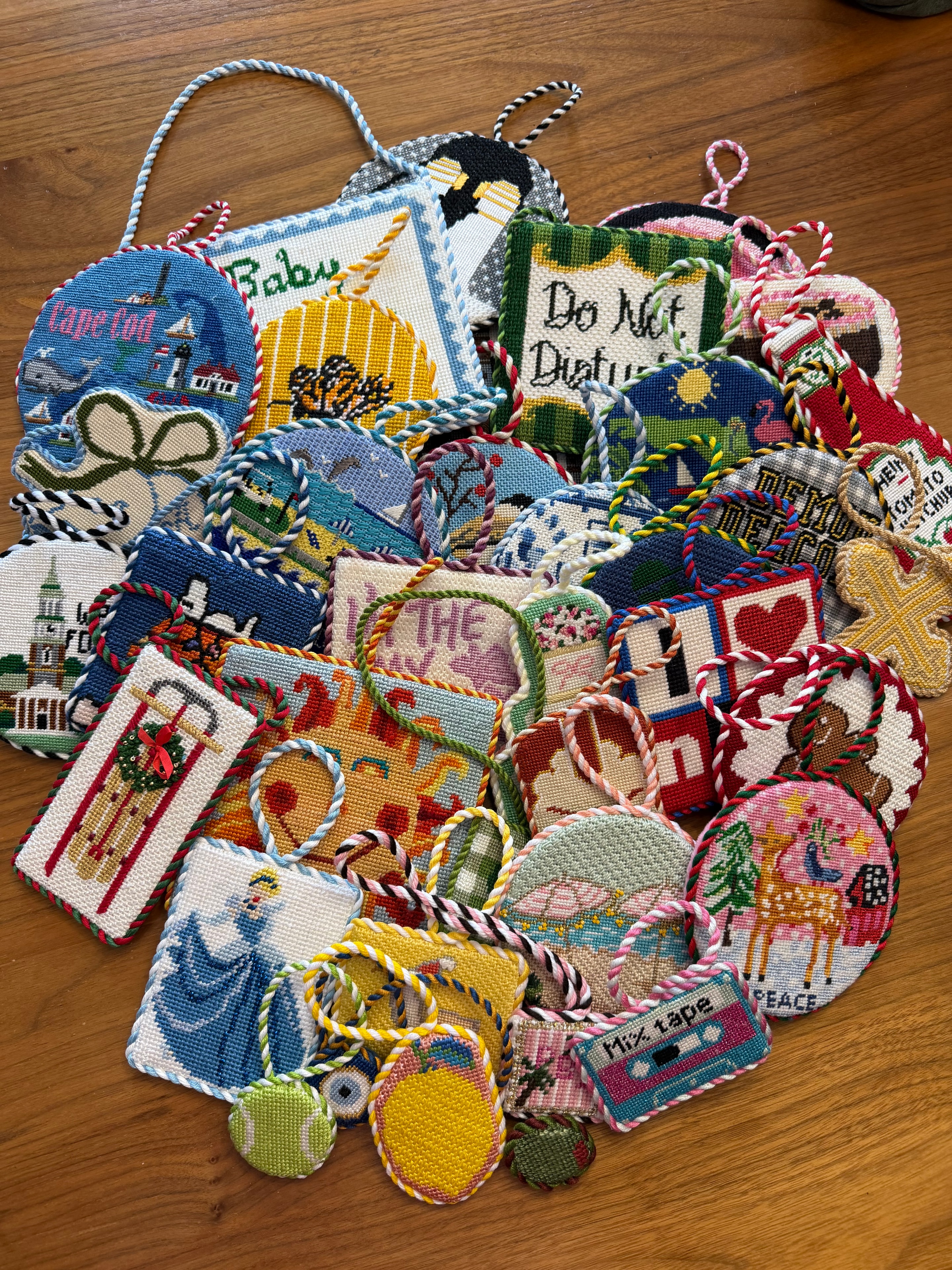 Collection of finished needlepoint holiday ornaments